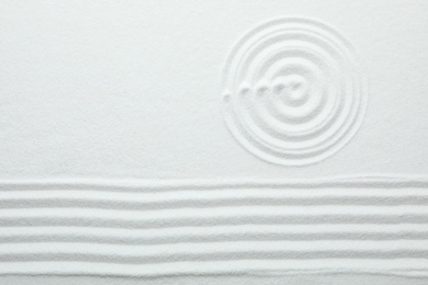 Photo of Top view of white sand with pattern. Zen and harmony