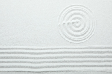 Top view of white sand with pattern. Zen and harmony