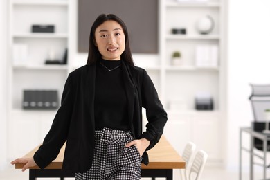 Portrait of smiling businesswoman in office. Space for text