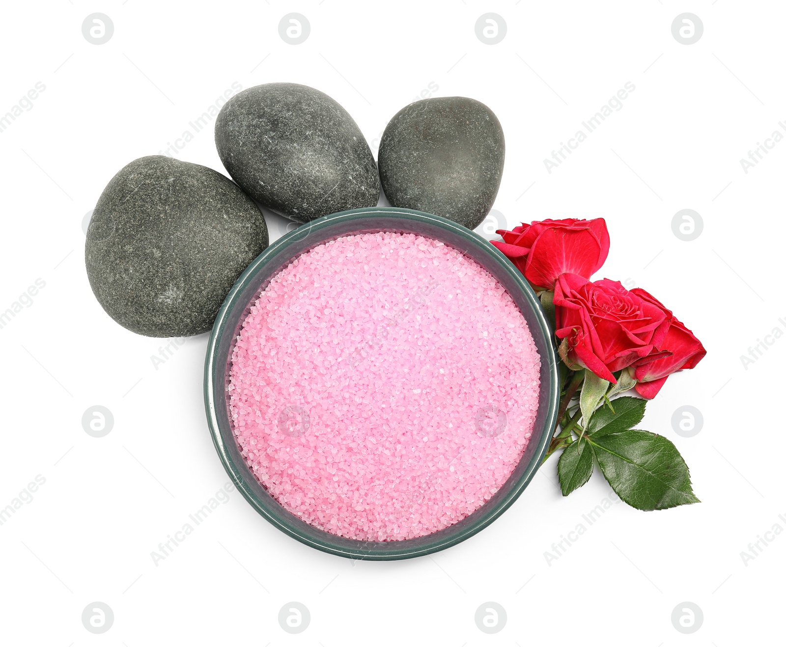 Photo of Pink sea salt in bowl, roses, spa stones and green leaves isolated on white, top view