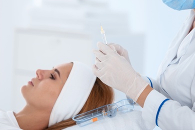Photo of Woman undergoing face biorevitalization procedure in salon. Cosmetic treatment