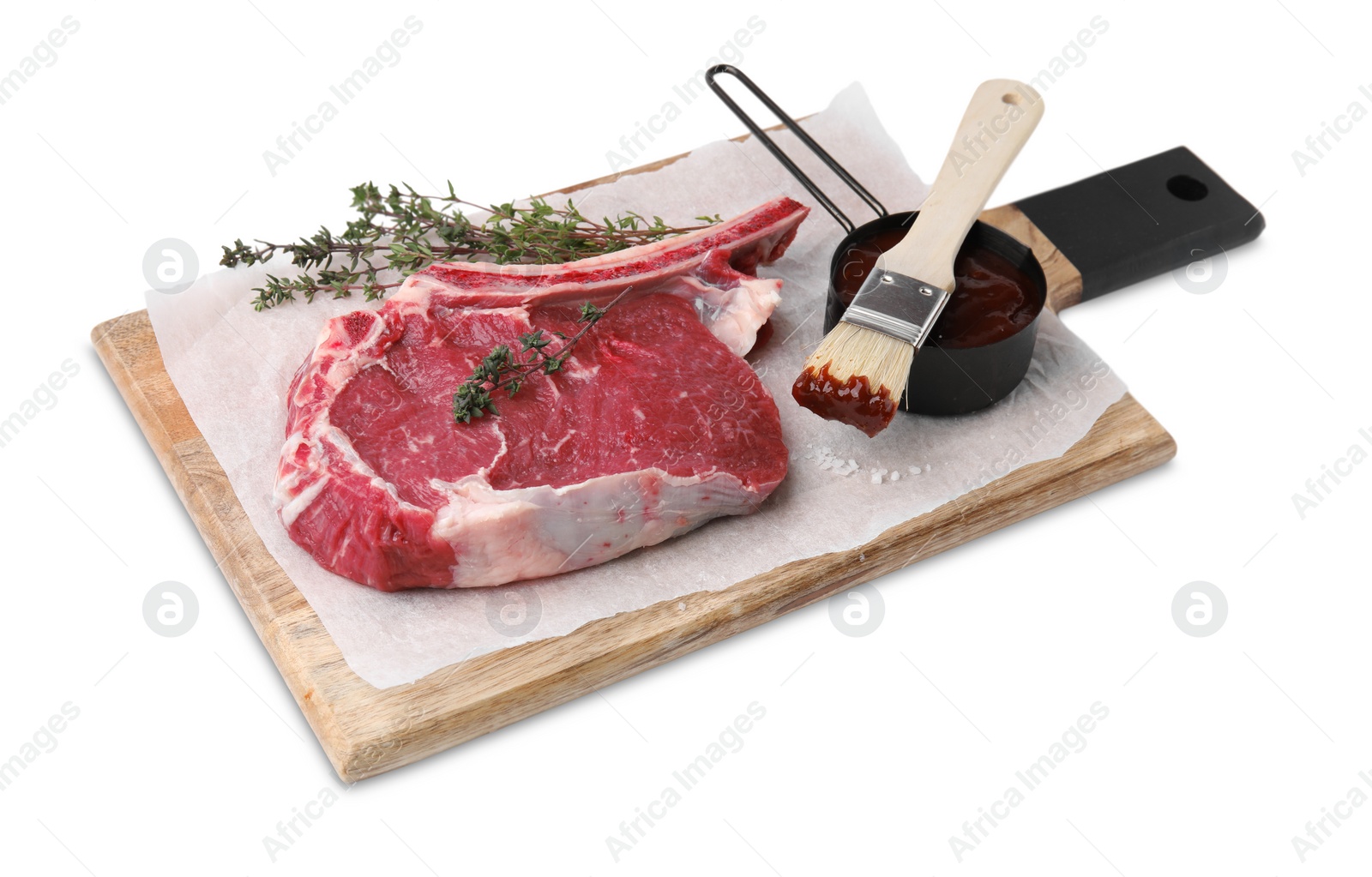 Photo of Board with raw meat, thyme and marinade isolated on white