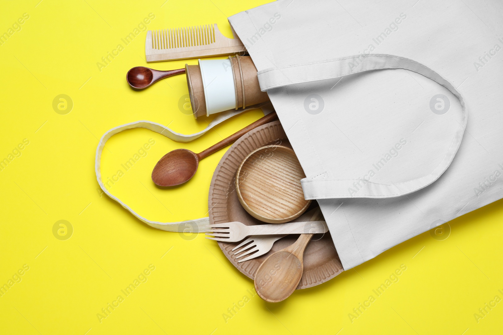 Photo of Eco bag with different disposable items on white background, top view. Recycling concept