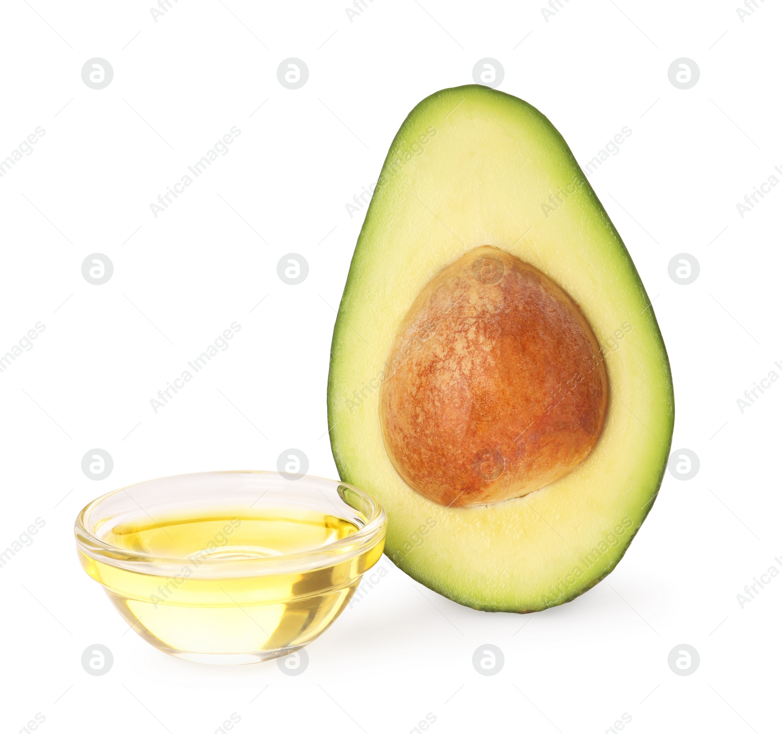 Photo of Cooking oil and half of fresh avocado isolated on white