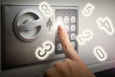 Woman pressing buttons on keypad to lock steel safe, closeup. Numbers symbolizing code combination flying around