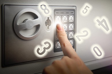 Image of Woman pressing buttons on keypad to lock steel safe, closeup. Numbers symbolizing code combination flying around