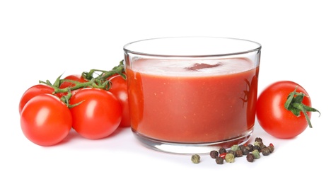 Photo of Glass of sauce, tomatoes and pepper isolated on white