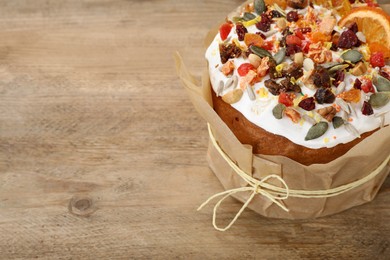 Traditional Easter cake with dried fruits on wooden table, space for text