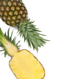 Photo of Whole and cut ripe pineapples on white background, flat lay. Space for text