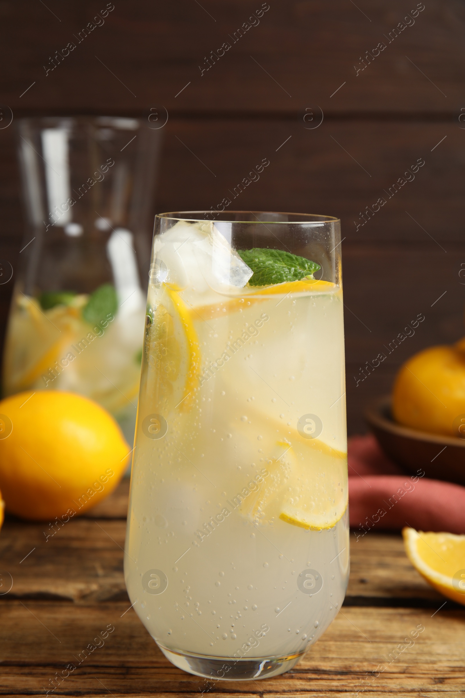 Photo of Cool freshly made lemonade on wooden table