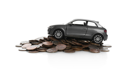 Miniature automobile model and money on white background. Car buying