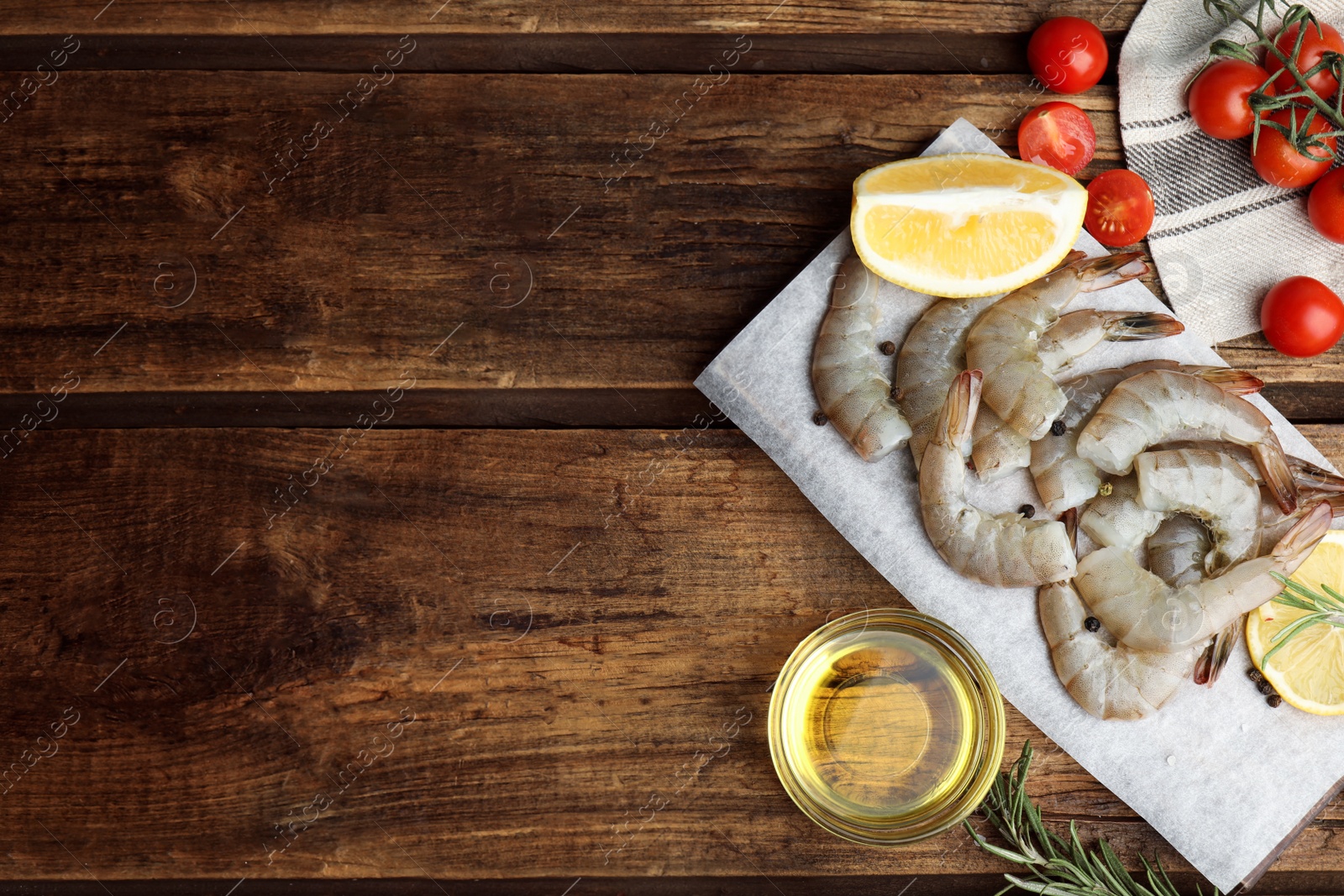 Photo of Flat lay composition with fresh raw shrimps on wooden table. Space for text