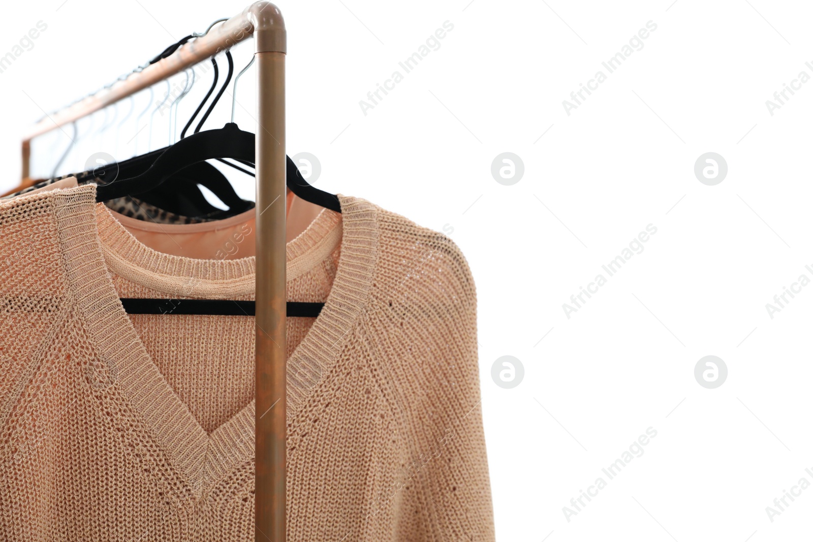 Photo of Different stylish clothes on rack in dressing room, closeup