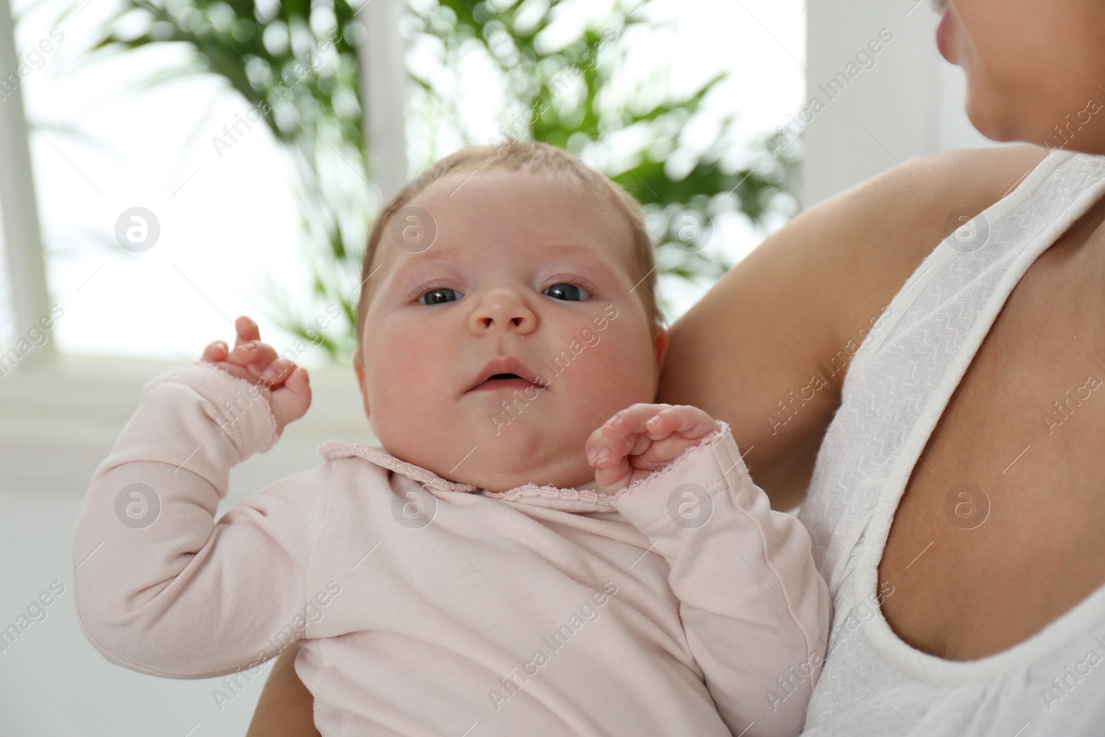 Photo of Young woman with her little baby resting after breast feeding at home, closeup