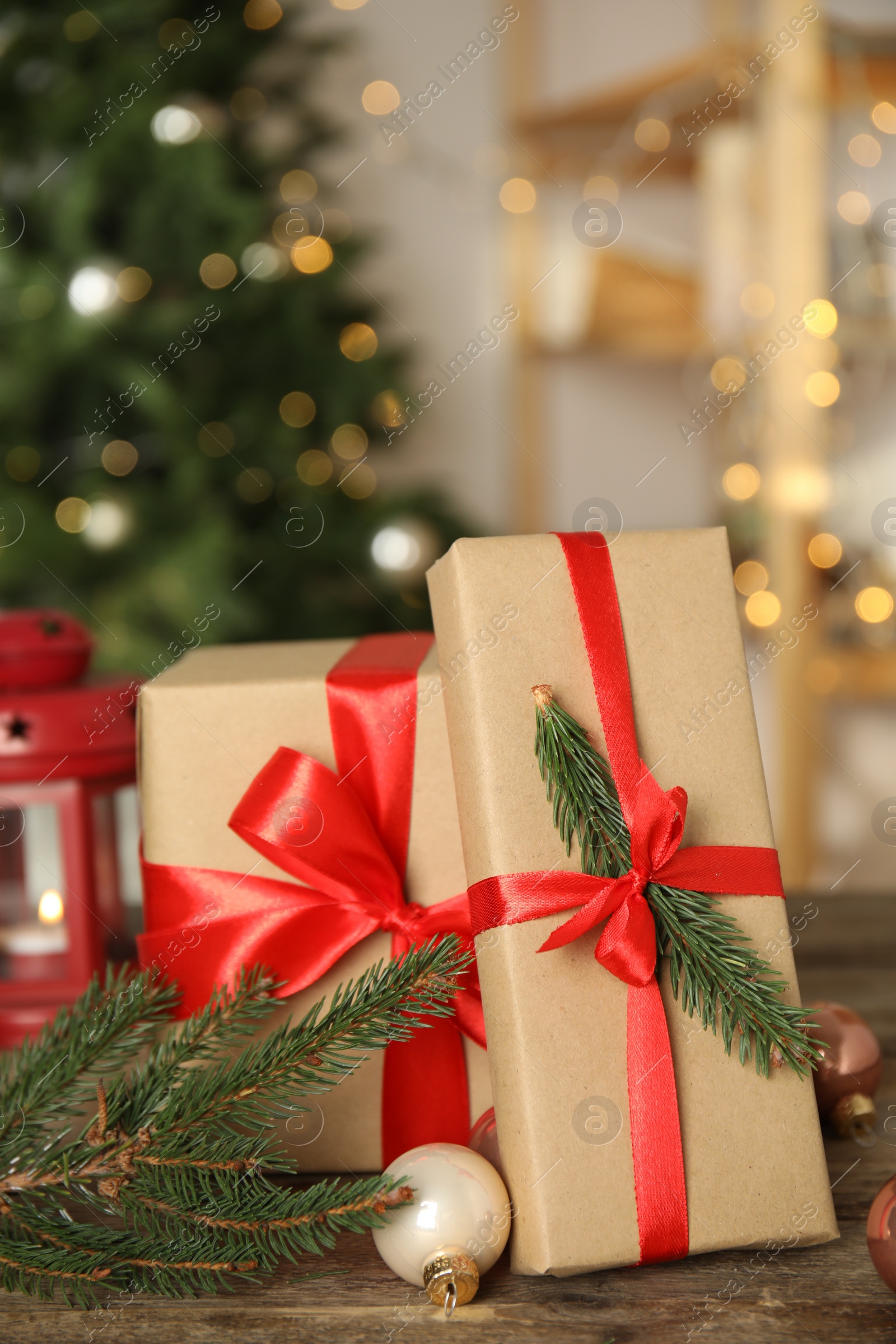 Photo of Beautiful gift boxes and Christmas decor on wooden table