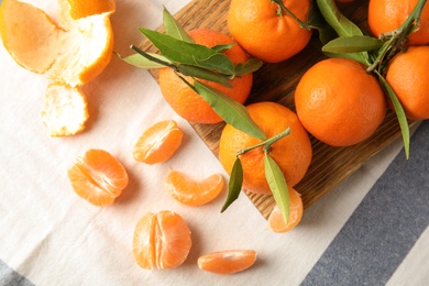 Photo of Flat lay composition with ripe tangerines on cloth