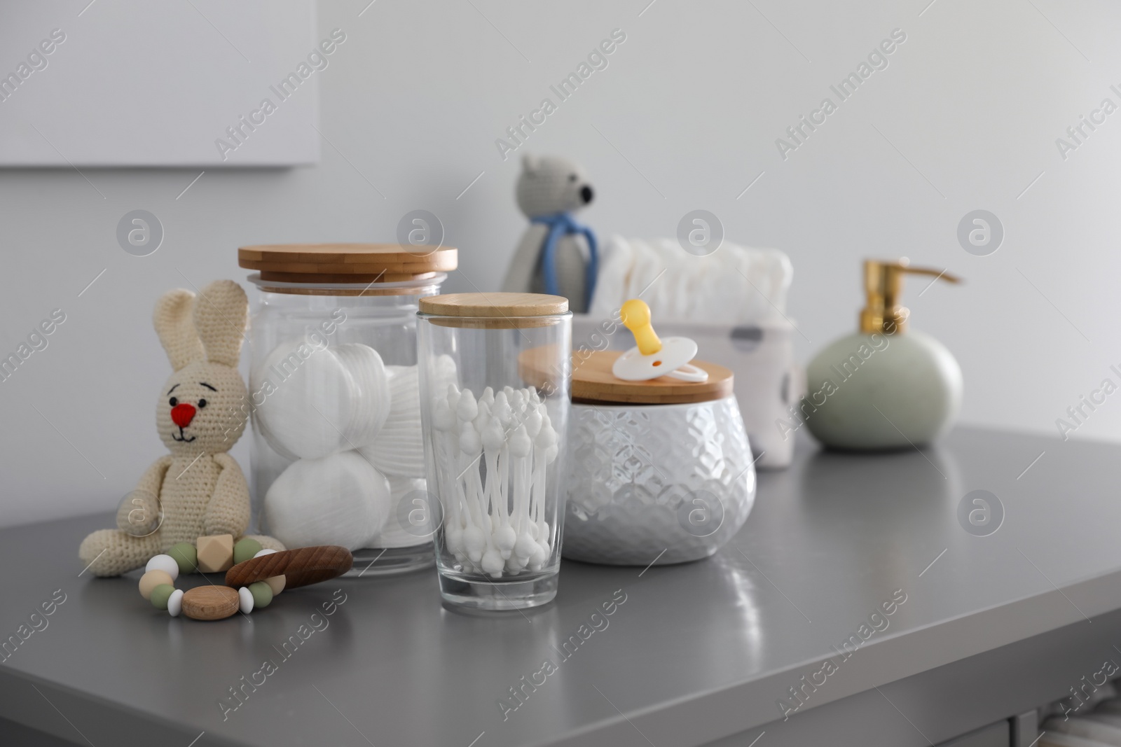 Photo of Baby accessories and toys on table in room