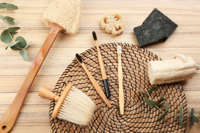 Photo of Flat lay composition with natural bamboo toothbrushes on wooden table