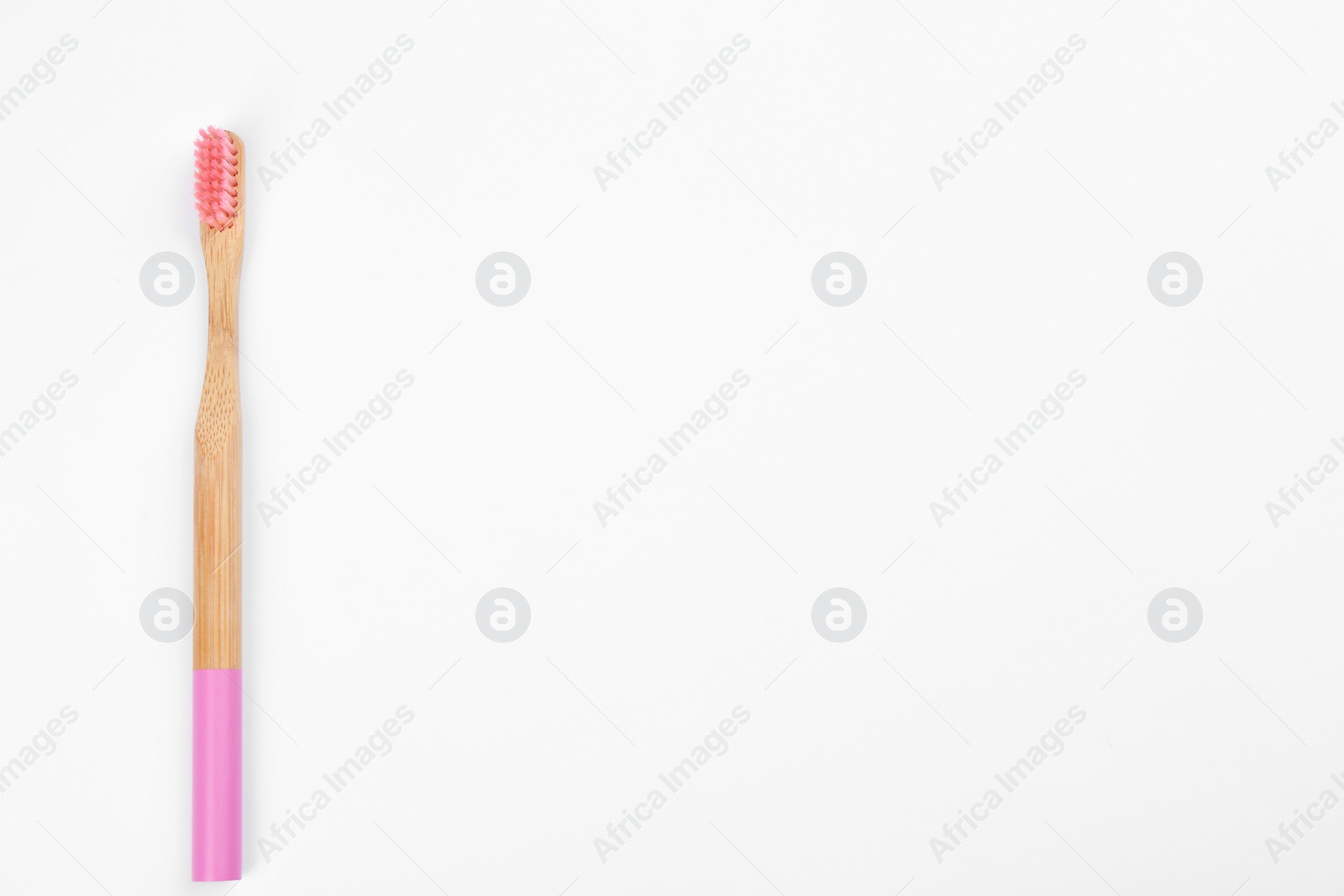 Photo of Bamboo toothbrush with pink bristle isolated on white, top view