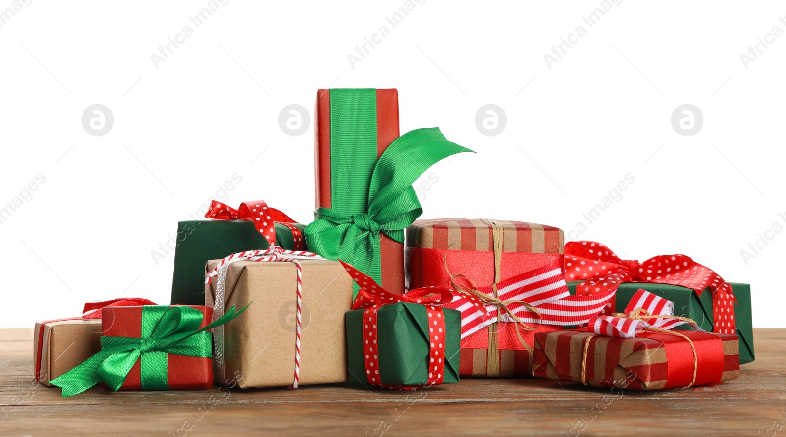 Photo of Many different Christmas gifts on wooden table against white background
