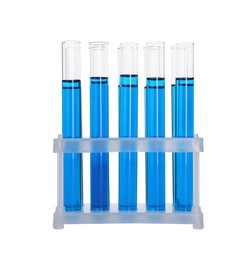 Photo of Many test tubes with light blue liquid in stand isolated on white