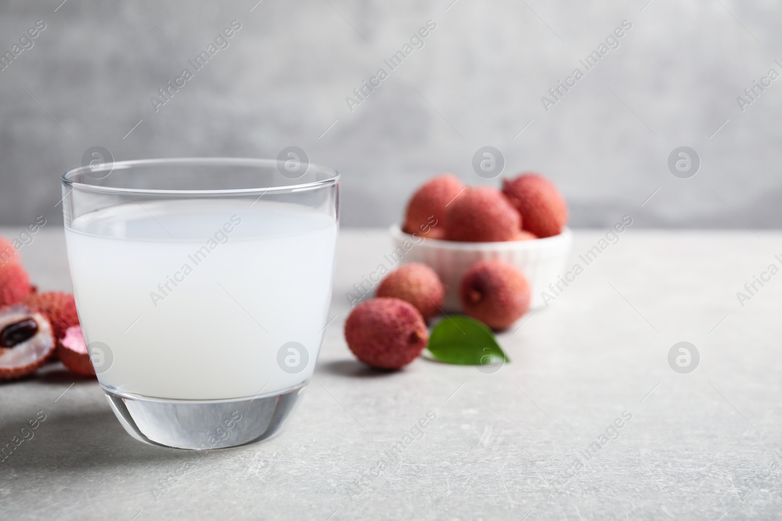Photo of Freshly made lychee juice on light table. Space for text