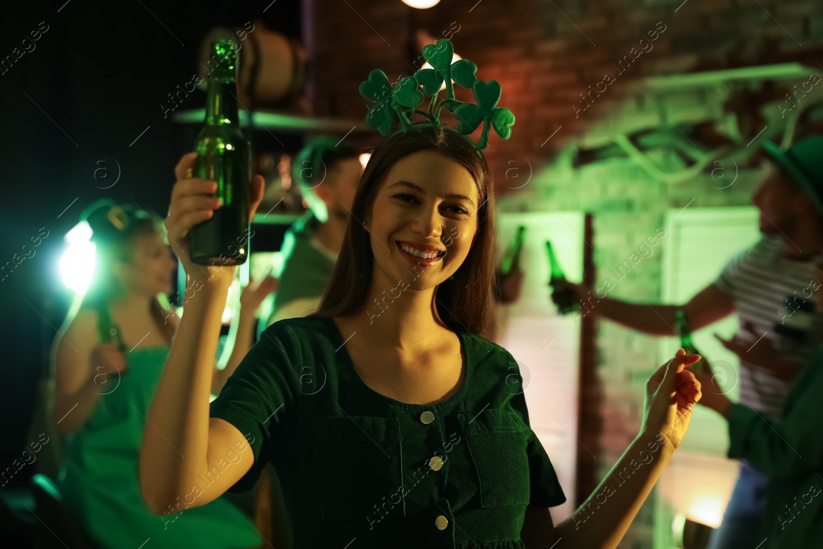 Photo of Woman with beer celebrating St Patrick's day in pub