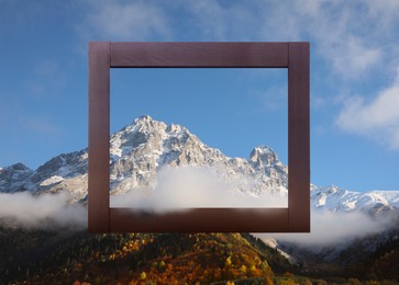 Image of Wooden frame and beautiful mountains with fog in morning