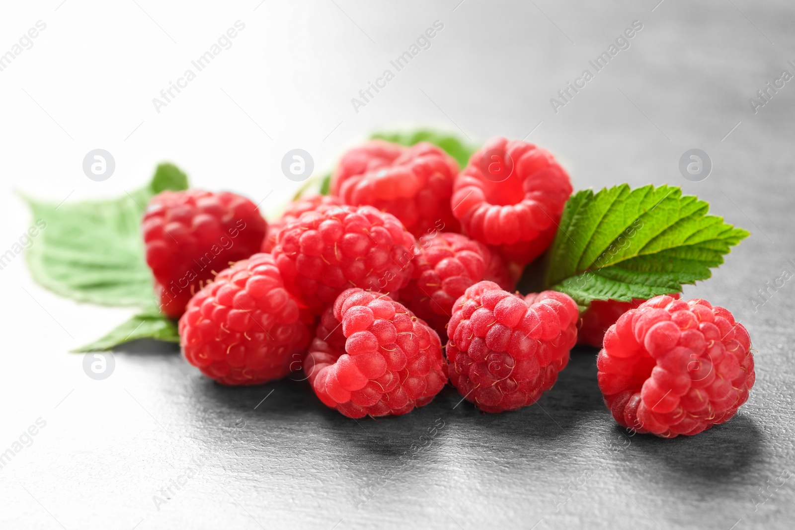 Photo of Ripe aromatic raspberries on table, closeup