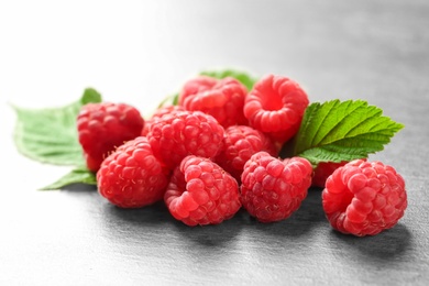 Photo of Ripe aromatic raspberries on table, closeup