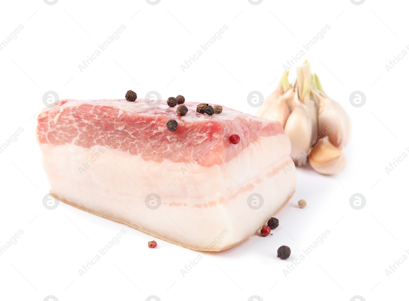 Photo of Piece of pork fatback with peppercorn and garlic isolated on white