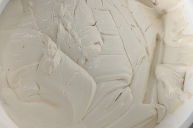 Photo of Texture of plaster in bucket, top view