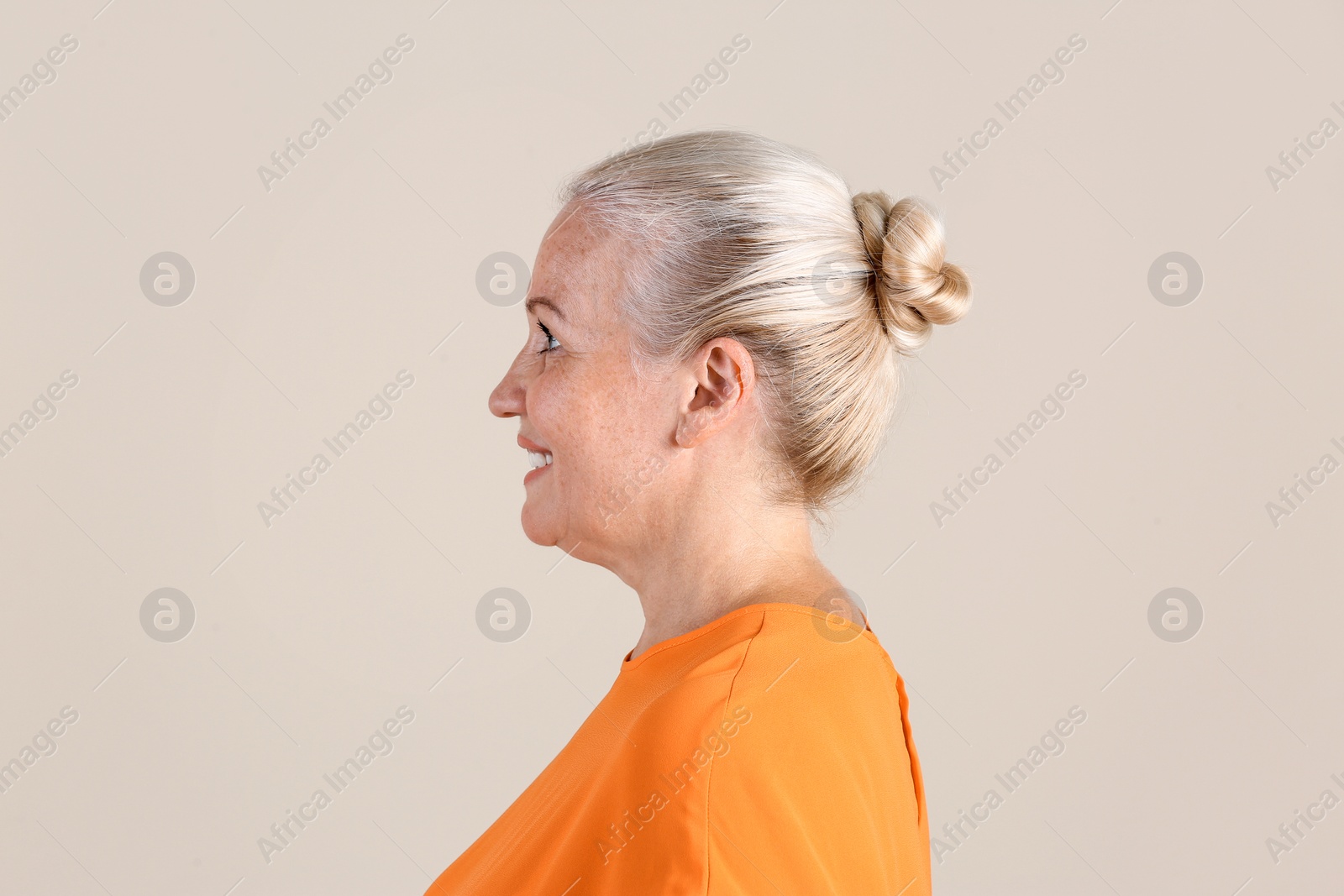 Photo of Mature woman on light background. Hearing problem