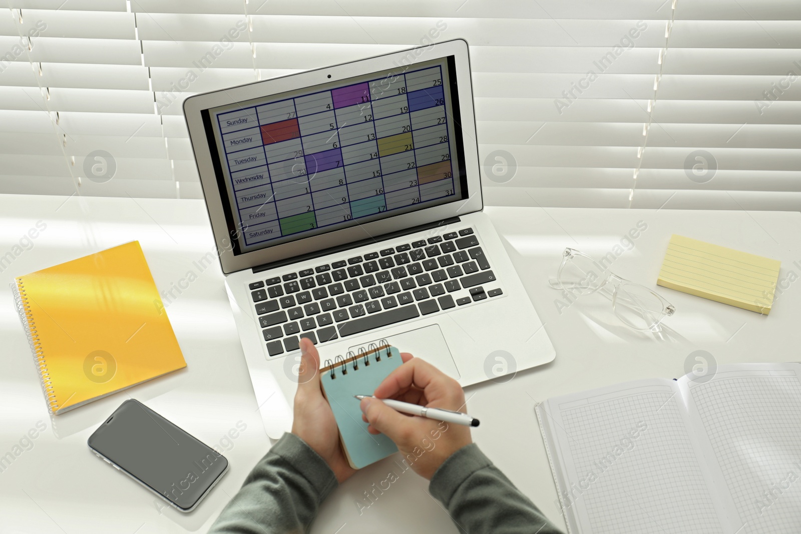 Photo of Man using calendar app on laptop in office, above view