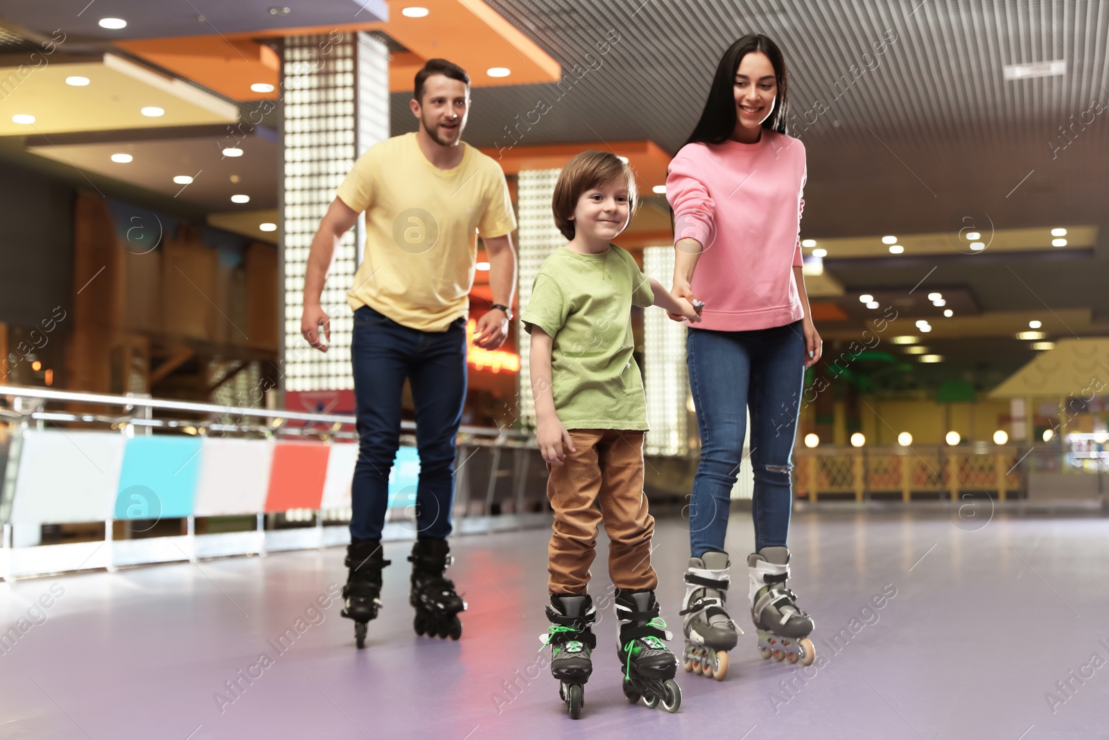 Photo of Happy family spending time at roller skating rink