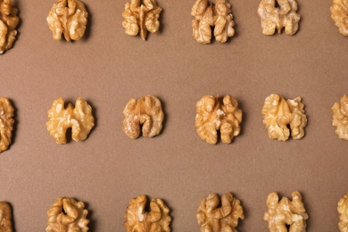 Tasty walnuts on color background, flat lay