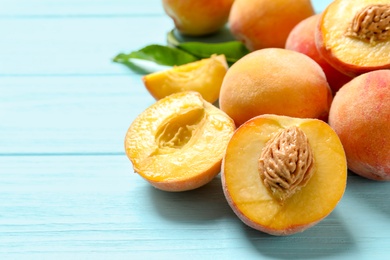 Fresh sweet peaches on wooden table, closeup