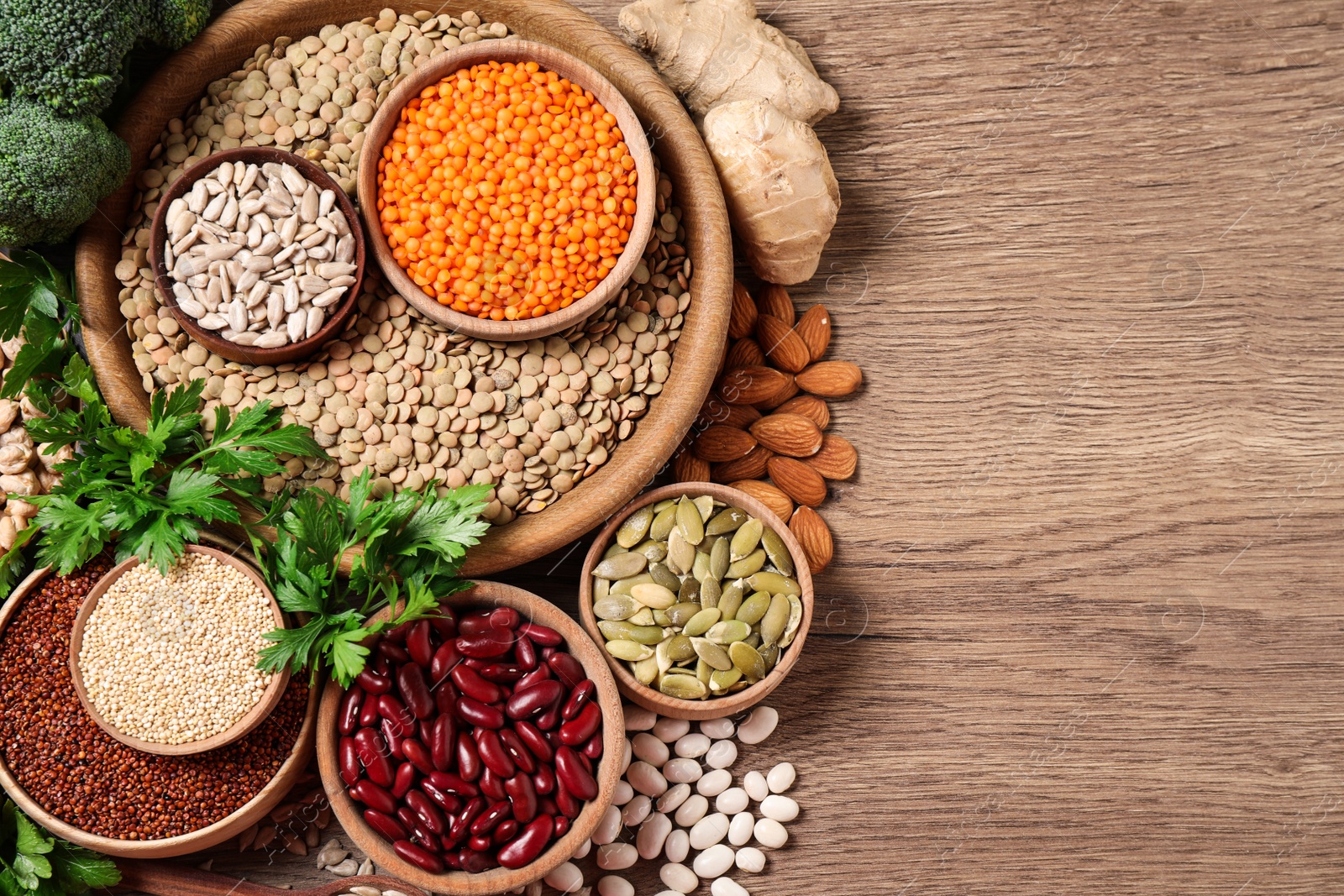 Photo of Fresh vegetables and seeds on wooden table, flat lay. Space for text