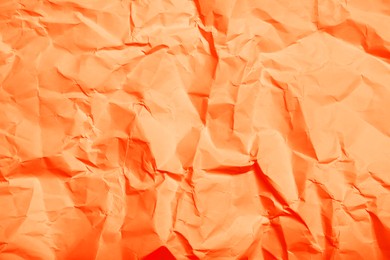 Image of Sheet of orange crumpled paper as background, top view