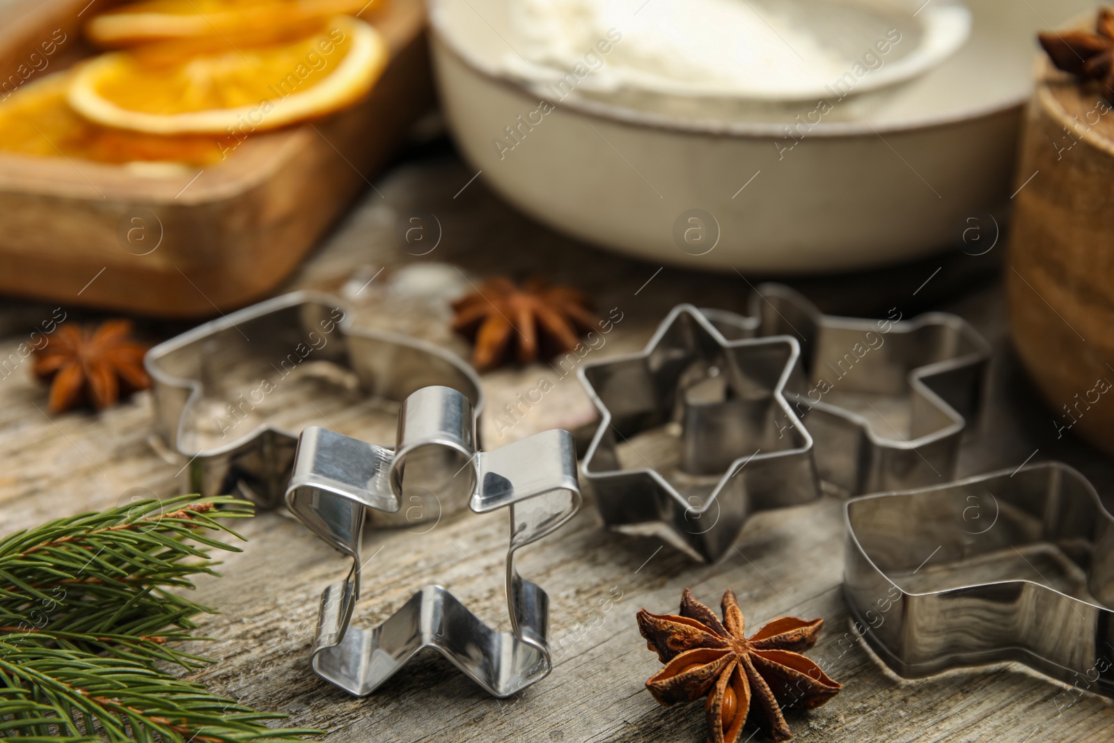 Photo of Cookie cutters on wooden table, closeup. Christmas biscuits