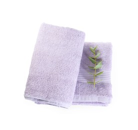 Photo of Violet terry towels and eucalyptus branch isolated on white, top view