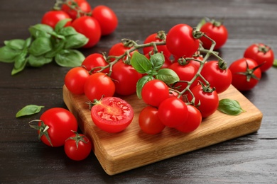 Fresh cherry tomatoes and basil on wooden table