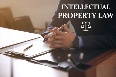 Image of Intellectual property law. Jurist at table in office, closeup