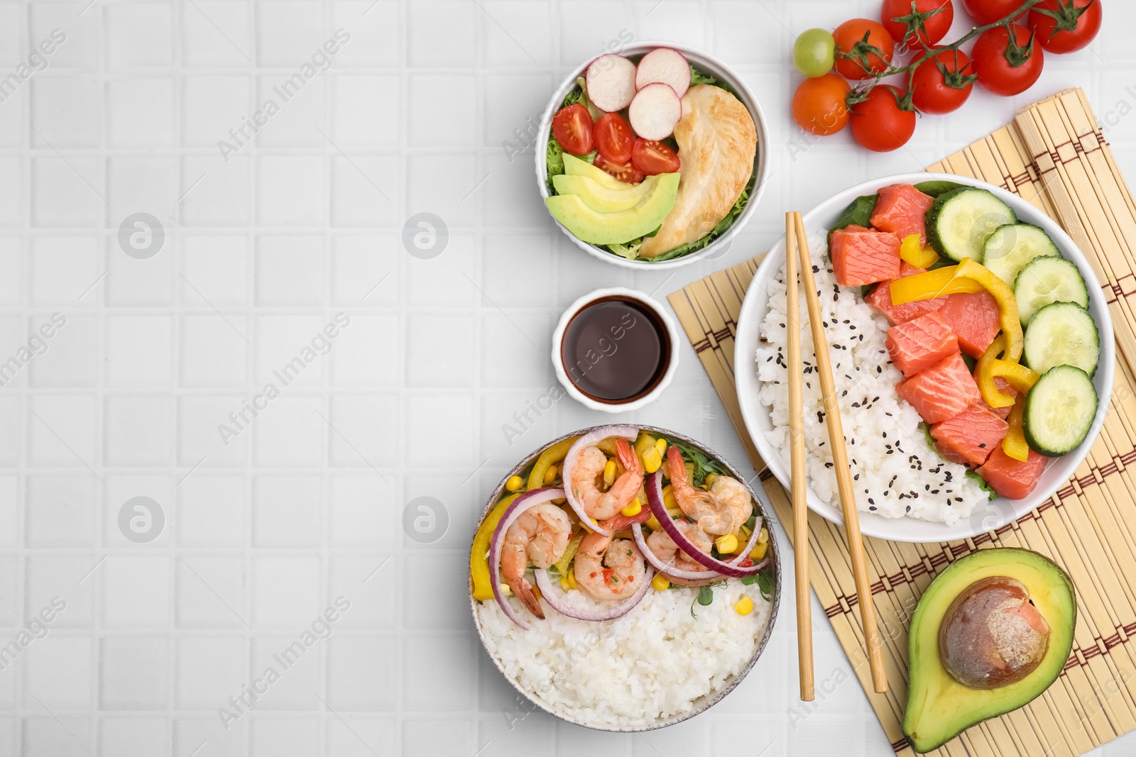 Photo of Set of delicious poke bowls with different ingredients on white table, flat lay. Space for text