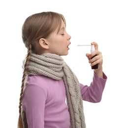 Little girl with scarf using throat spray on white background