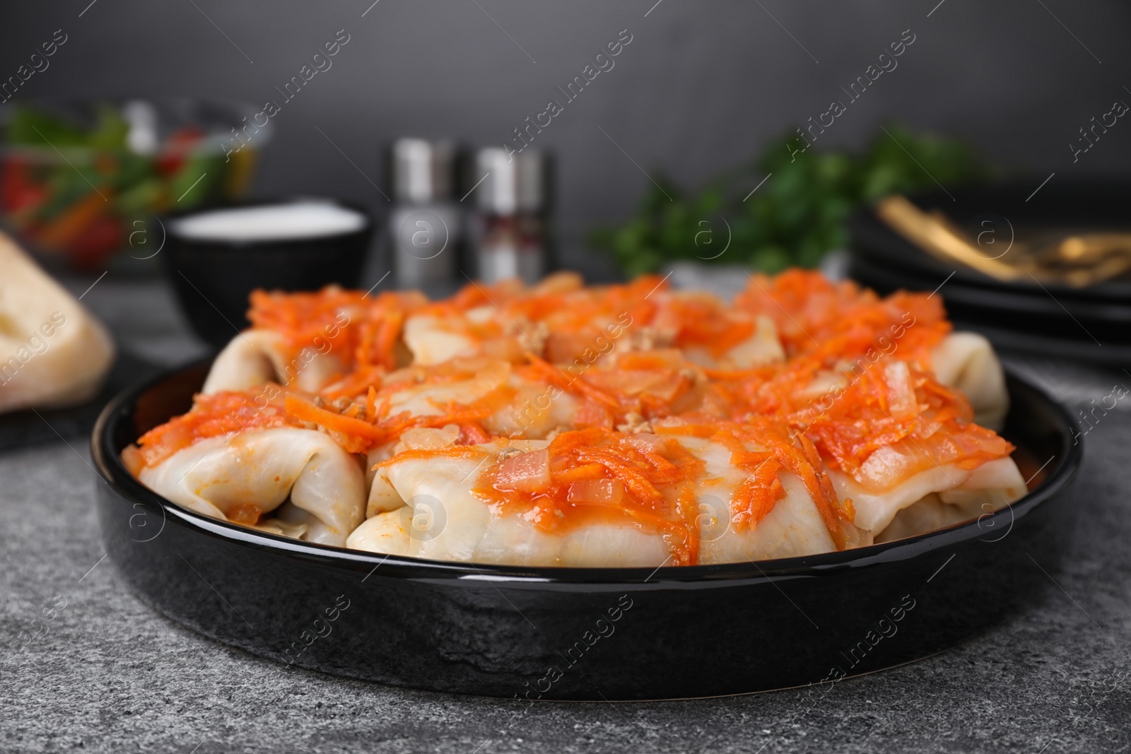 Photo of Delicious cabbage rolls served on grey table, closeup