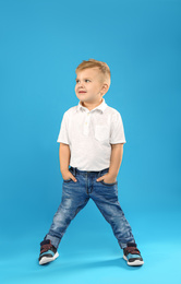 Photo of Cute little boy posing on blue background