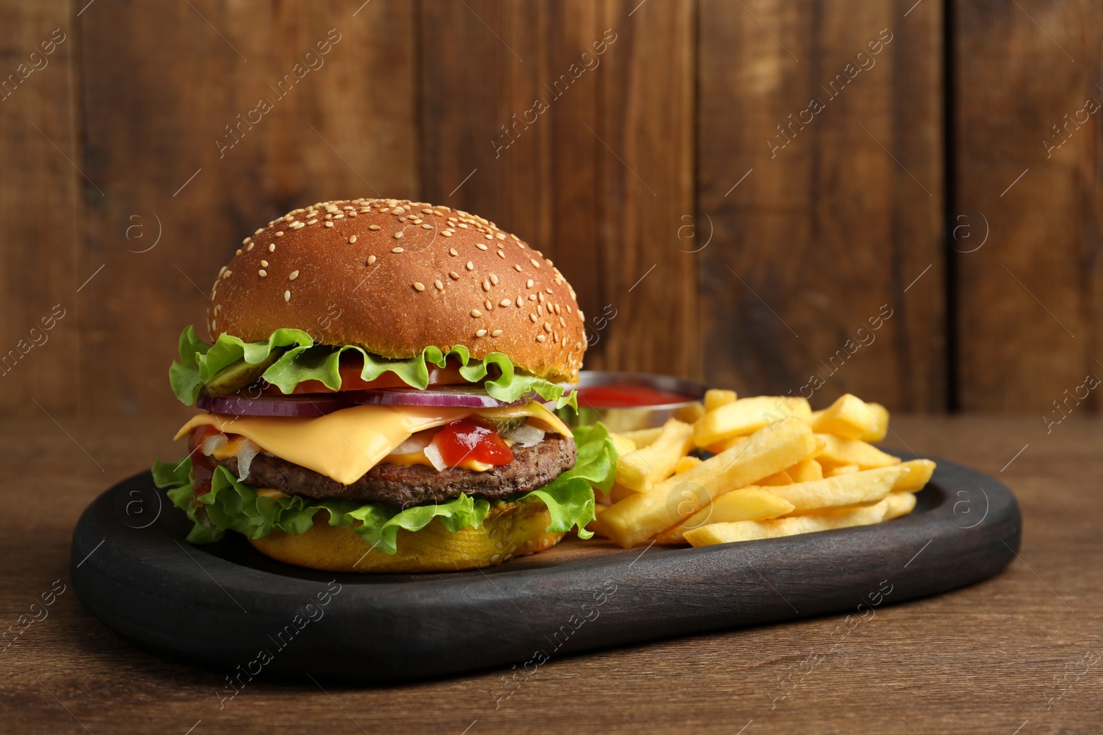 Photo of Delicious burger with beef patty and french fries on wooden table