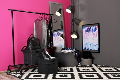 Stylish dressing room interior with clothes rack and mirror