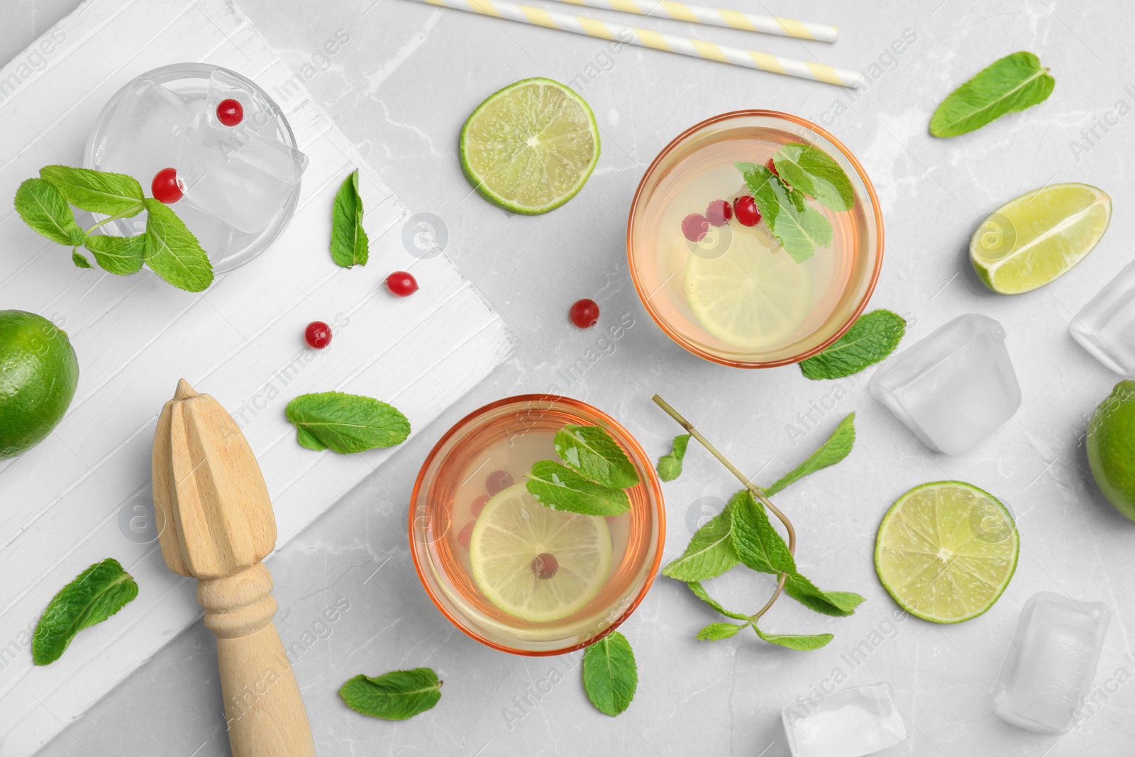 Photo of Flat lay composition with delicious natural lemonade on light background